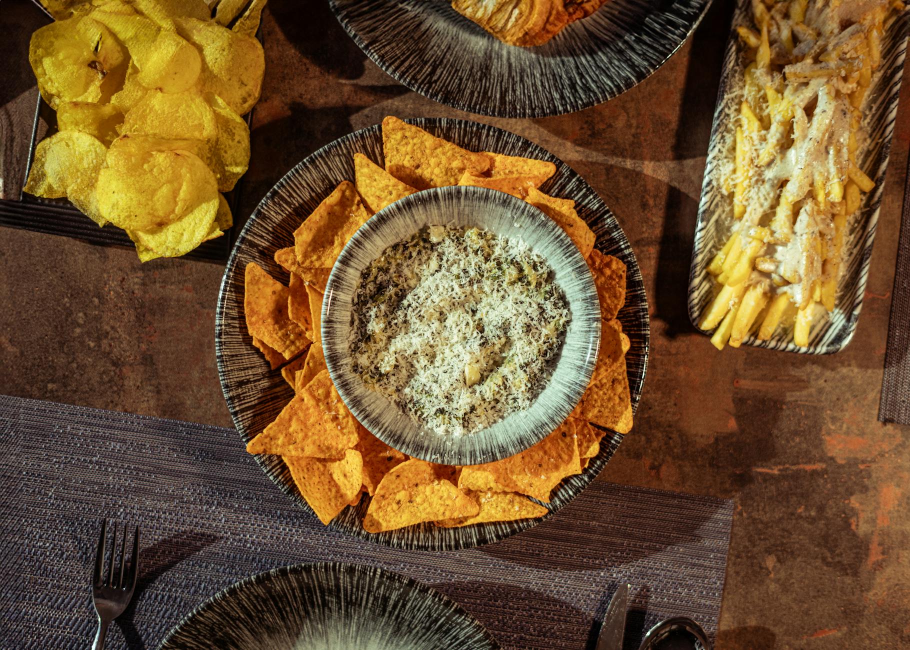 variety of snacks and pasta on rustic table