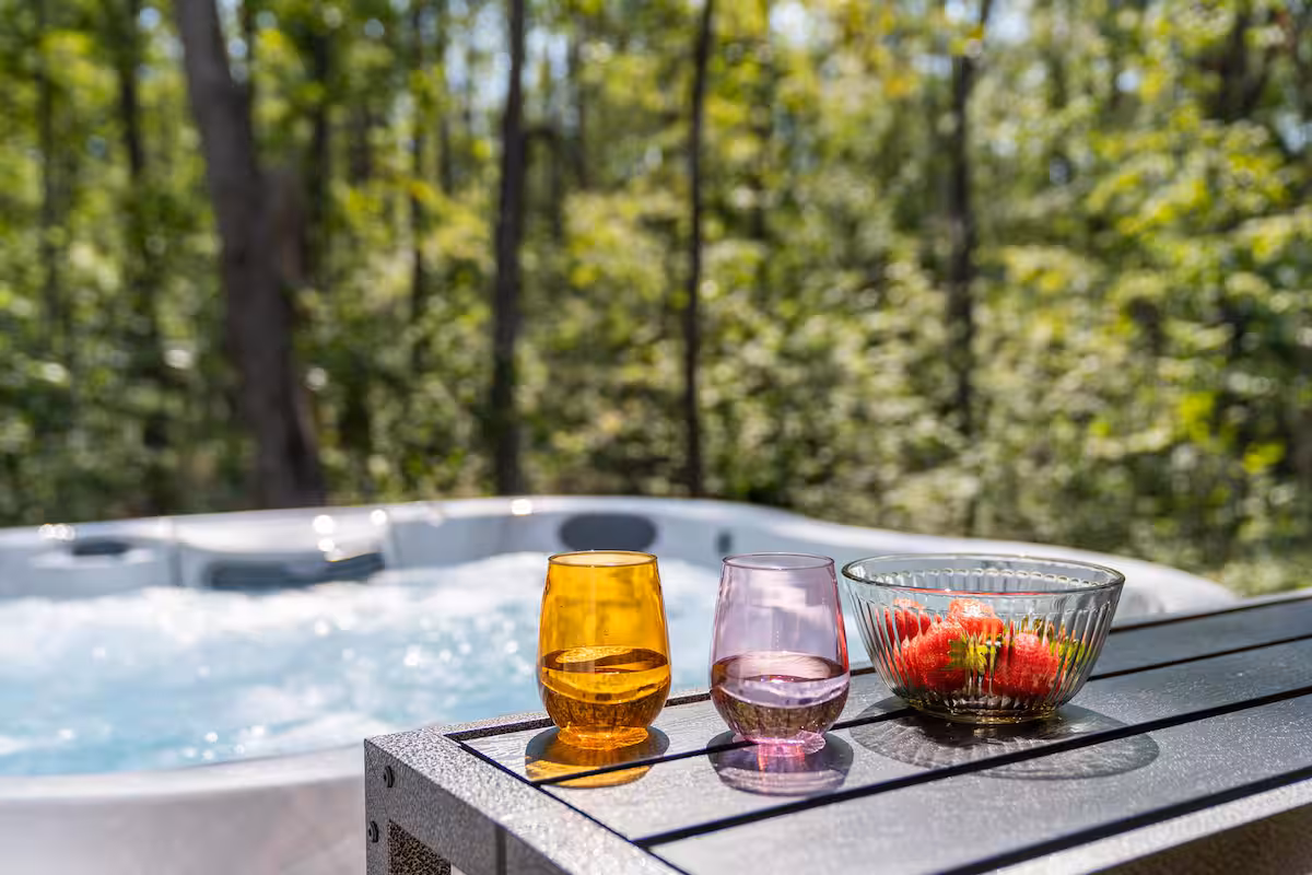 Private hot tub on the back deck of The Bird House vacation rental in Harbor Springs Michigan surrounded by trees