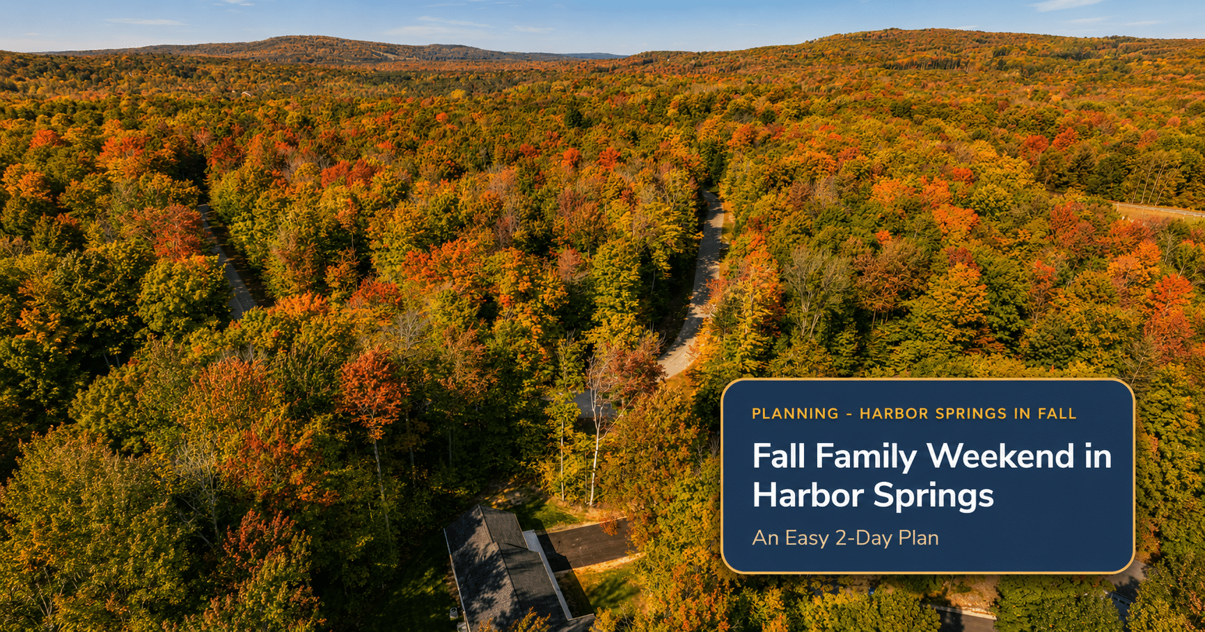 Aerial view of fall color over the woods surrounding The Bird House, a family vacation rental near Harbor Springs, Michigan